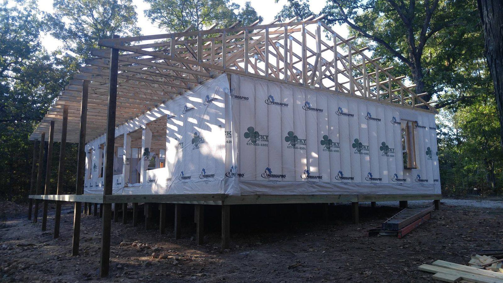 A Lucky house package going up, framed and wrapped