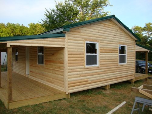 A cabin finished in Lucky log siding with a covered porch