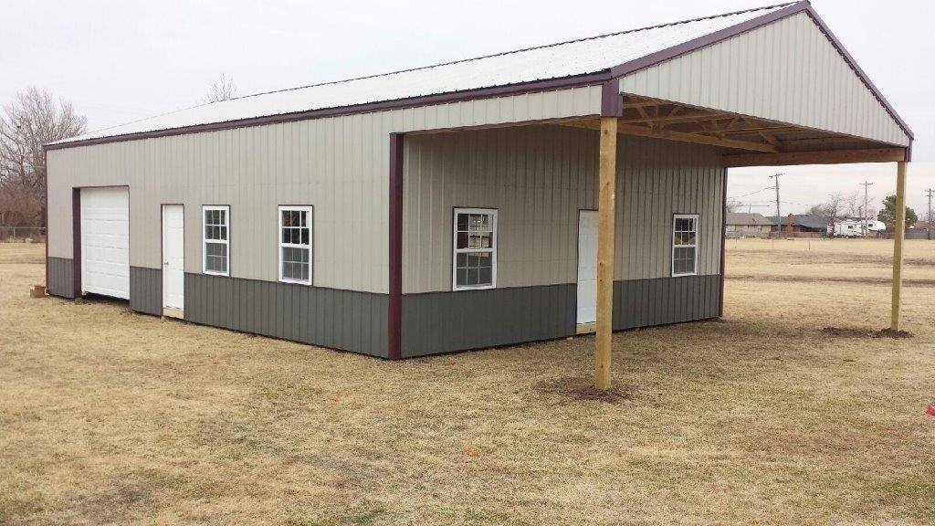 A tan and gray Lucky pole barn with an overhead door, walk doors, windows and a covered end